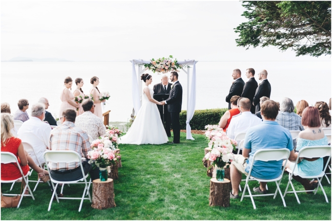  Photo of beach wedding ceremony with bride and groom looking at each other
