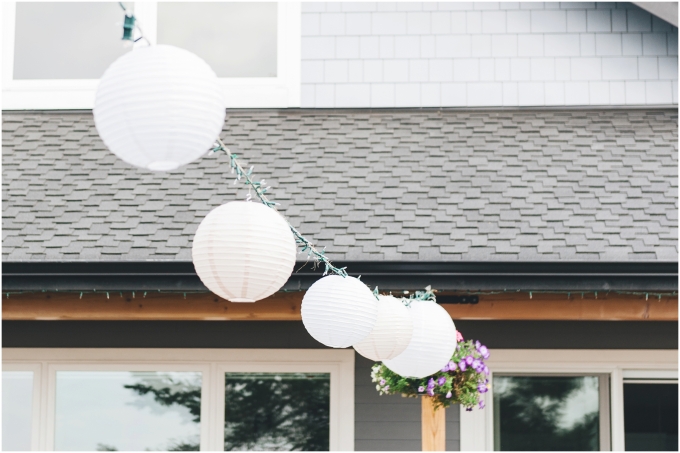 White paper lanterns are used as decorations for a backyard beach wedding in Bellingham