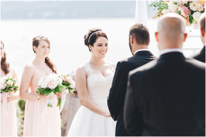  Photo of beach wedding ceremony with bride and groom looking at each other