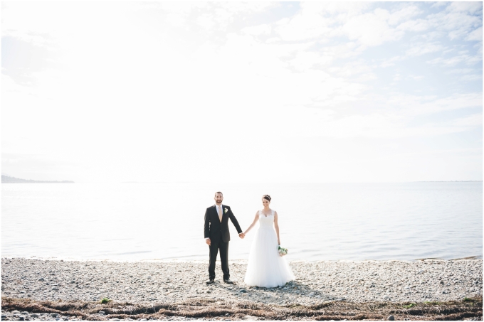 Bride and groom wedding portraits on the beach in Bellingham, backlit, 