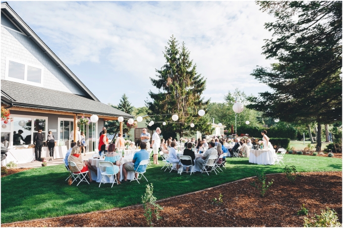 A wide view of a backyard wedding on a beach in Bellingham