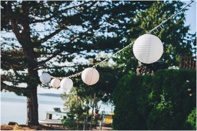 White paper lanterns are used as decorations for a backyard beach wedding in Bellingham