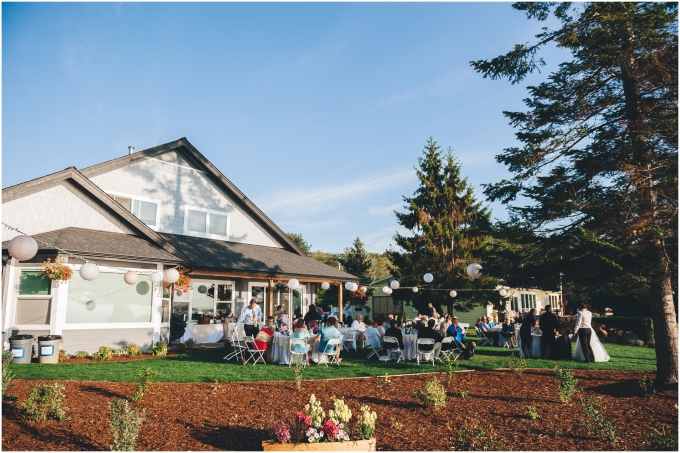A wide view of a backyard wedding on a beach in Bellingham